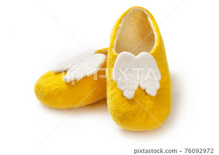Felt slippers on white background in closeup Felt slippers on white background in closeup 76092972