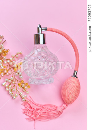 vintage perfume bottle with atomizer on pink background. 76093705