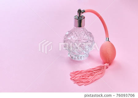 vintage perfume bottle with atomizer on pink background. vintage perfume bottle with atomizer on pink background. 76093706