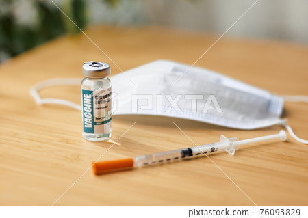 Coronavirus or COVID-19, 2019 - nCoV vaccine in a bottle with syringe 76093829