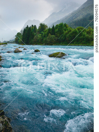 Misty landscape with Oldeelva glacier river in Norway 76094076