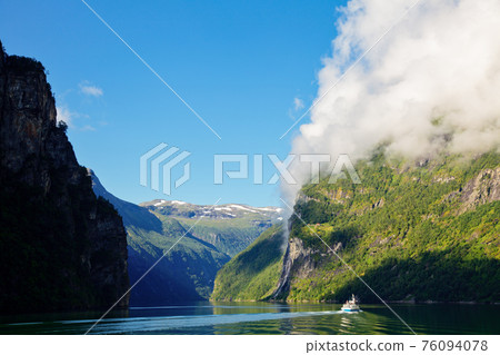 Cliff with cloud at Geirangerfjord in Norway Cliff with cloud at Geirangerfjord in Norway 76094078
