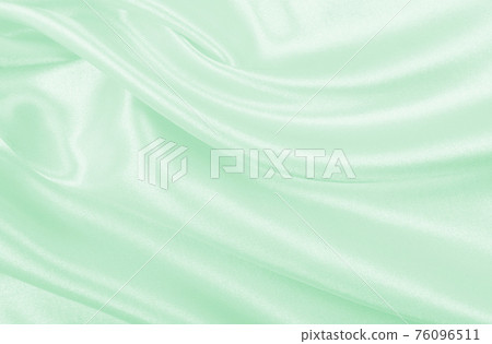 Smooth elegant green silk or satin luxury cloth texture as abstract background. Luxurious background design 76096511