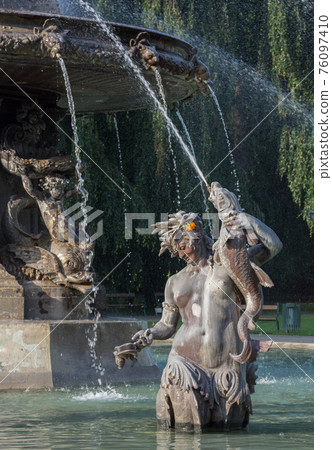 Fountain in the city park Stadtpark, a green island in the middle of the city, in Graz, Styria region, Austria. 76097410