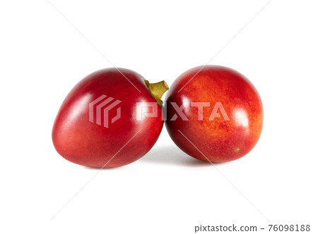 Tamarillo isolated on a white background. Two whole red fruits. Tamarillo isolated on a white background. Two whole red fruits. 76098188