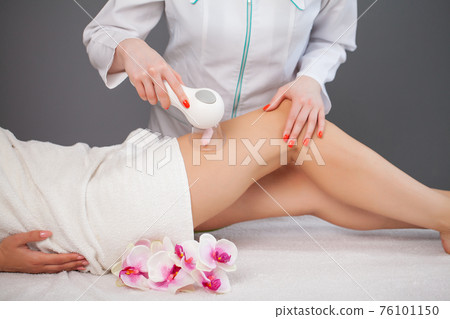 Woman getting anti-cellulite massage of leg with use of vacuum cans Woman getting anti-cellulite massage of leg with use of vacuum cans 76101150