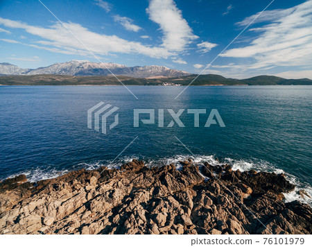 Rocky coastline on the Lustica peninsula overlooking Mount Lovcen in Montenegro. Aerial top view. Rocky coastline on the Lustica peninsula overlooking Mount Lovcen in Montenegro. Aerial top view. 76101979