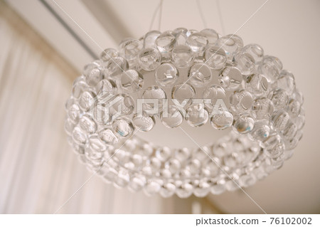 Stylish hi-tech chandelier made of transparent acrylic balls. Stylish hi-tech chandelier made of transparent acrylic balls. 76102002