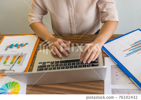 Aerial view of woman hand working on laptop Aerial view of woman hand working on laptop 76102432