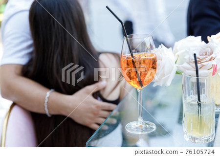 Glasses with alcoholic and soft drinks stand on the bar 76105724