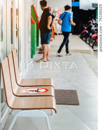 Alternative seating mark for social distance rules in front of the bank distance for one seat from other people to protect from Corona Virus(COVID-19), Social distancing for infection risk. 76106029