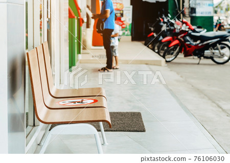 Alternative seating mark for social distance rules in front of the bank distance for one seat from other people to protect from Corona Virus(COVID-19), Social distancing for infection risk. 76106030