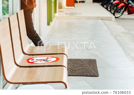 Alternative seating mark for social distance rules in front of the bank distance for one seat from other people to protect from Corona Virus(COVID-19), Social distancing for infection risk. 76106033