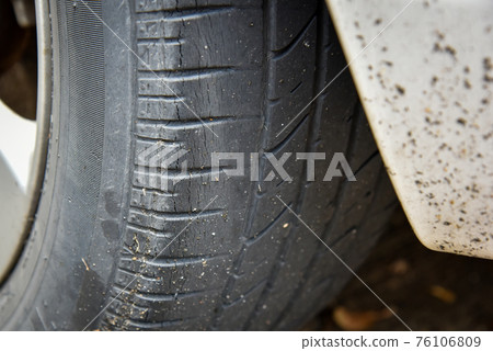 Old tire with worn tread and scratch Old tire with worn tread and scratch 76106809