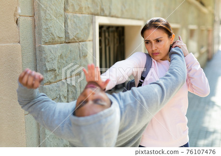Woman defends herself from attacker rapist on street 76107476