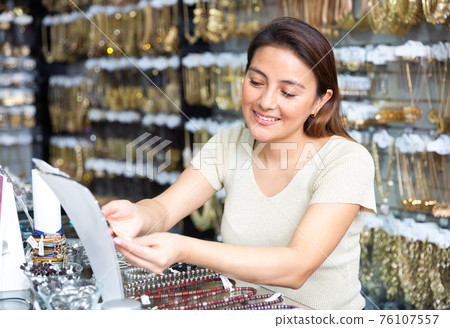 Portrait of woman shopping in jewelry store Portrait of woman shopping in jewelry store 76107557