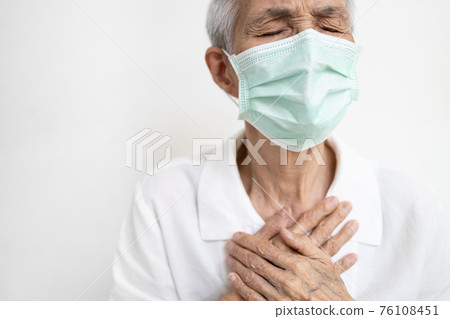Asian senior grandmother suffering from pain in chest with acute dyspnea or asthma disease,Tired old elderly eyes closed and hand touch her chest,difficulty breathing,shortness of breath,breathless 76108451
