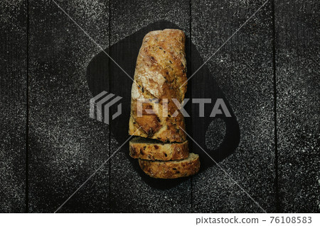 Fresh baked bread on the wooden table 76108583