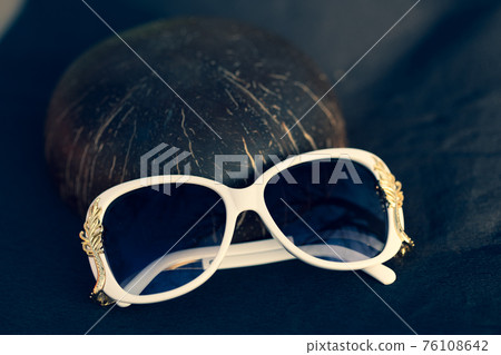 Sunglasses white model for women with a special design shoot outside in nature in a sunny day . Selective focus  76108642