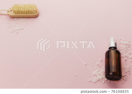 Bottle of cosmetic oil and brush on pink background 76108835