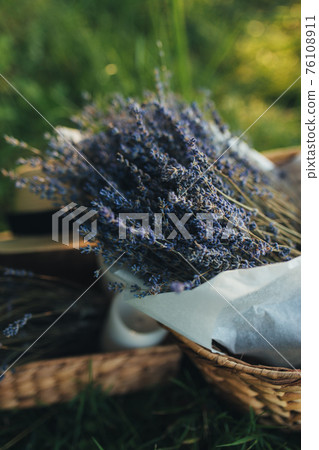Purple lavender flowers in the wooden box. Blurred background Purple lavender flowers in the wooden box. Blurred background 76108911