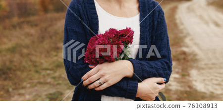 Girl holding red peonies. Present from boyfriend Girl holding red peonies. Present from boyfriend 76108913
