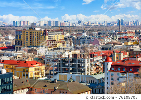 Construction of a new multi-storey residential building in the old part of the city of Kyiv against the background of the city landscape, view from above. Construction of a new multi-storey residential building in the old part of the city of Kyiv against the background of the city landscape, view from above. 76109705