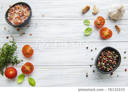 Tomato, basil and pepper with garlic on white wooden background Tomato, basil and pepper with garlic on white wooden background 76110335