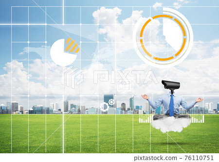 Camera headed man sitting in lotus pose on cloud against modern cityscape 76110751