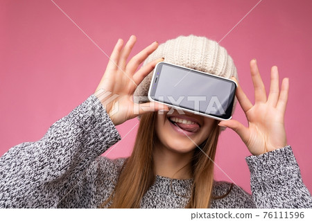 Closeup photo of sexy smiling Beautiful young blonde woman wearing casual grey sweater and beige hat Closeup photo of sexy smiling Beautiful young blonde woman wearing casual grey sweater and beige hat 76111596