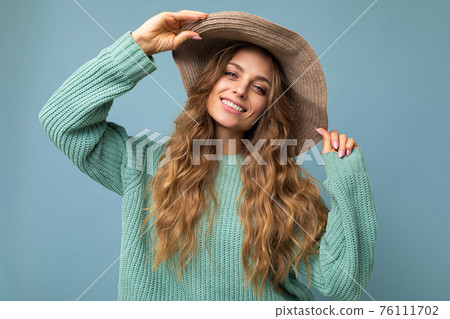 Young beautiful cute curly blonde woman with sexy expression, cheerful and happy face wearing trendy 76111702