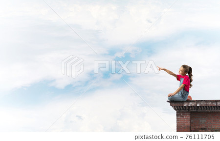 Concept of careless happy childhood with girl showing touch gesture Concept of careless happy childhood with girl showing touch gesture 76111705