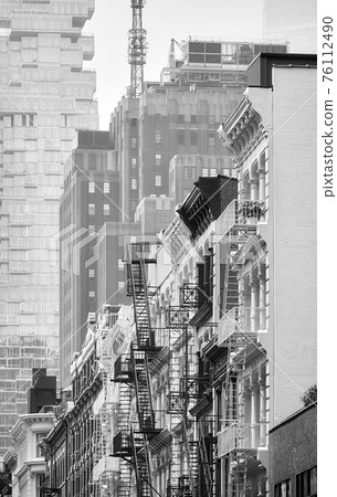 Row of old building with iron fire escapes, black and white picture of New York cityscape, USA. 76112490