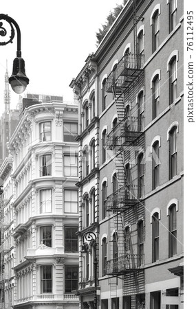 Old building with iron fire escapes, black and white picture of New York cityscape, USA. Old building with iron fire escapes, black and white picture of New York cityscape, USA. 76112495