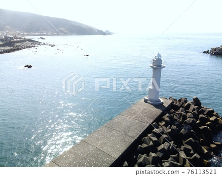 Aerial view of the Ainuma fishing port white lighthouse in the Kumaishi district of Yakumo-cho, Hokkaido in early spring Aerial view of the Ainuma fishing port white lighthouse in the Kumaishi district of Yakumo-cho, Hokkaido in early spring 76113521