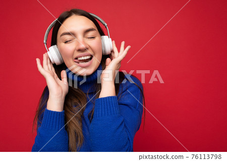 Closeup portrait of sexy beautiful happy smiling young brunette female person wearing blue sweater Closeup portrait of sexy beautiful happy smiling young brunette female person wearing blue sweater 76113798