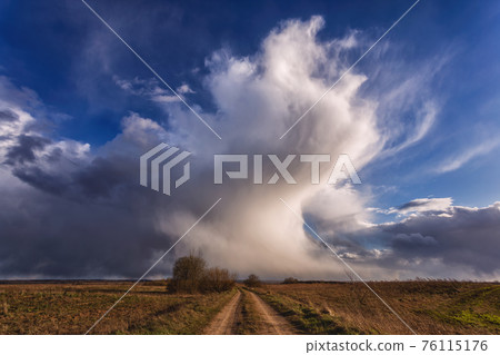 Spring landscape with meadow road and clouds 76115176