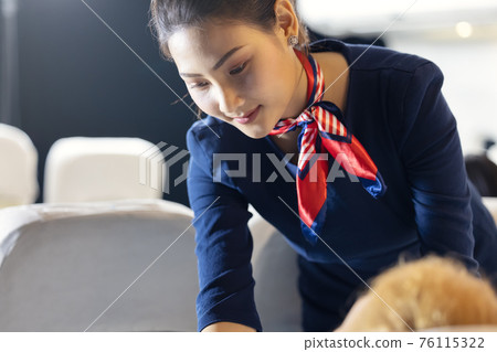 Air hostess or stewardess wearing protective face mask service taking cover cloth for passengers on the airplane , when she sleeping at night 76115322