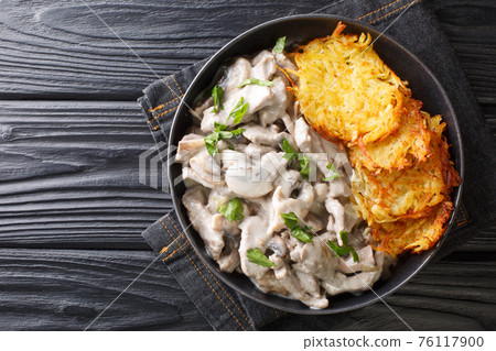 Zurich Geschnetzeltes a classic Swiss Veal Dish closeup in the plate. Horizontal top view 76117900