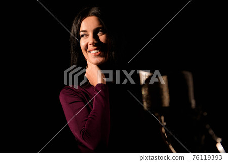 Portrait of woman recording a song in a professional studio 76119393