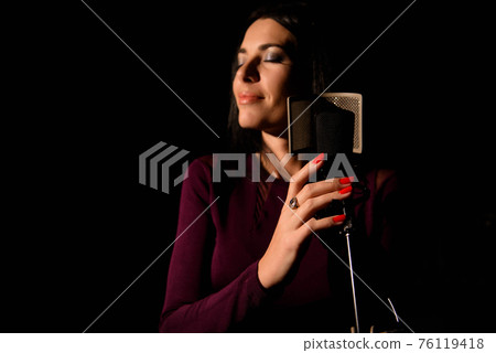 Professional musician recording new song in studio. Professional musician recording new song in studio. 76119418