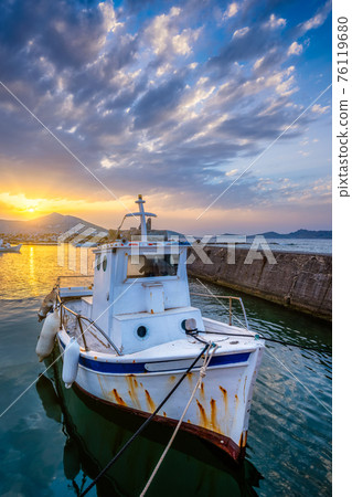 Fishing boat in port of Naousa on sunset. Paros lsland, Greece Fishing boat in port of Naousa on sunset. Paros lsland, Greece 76119680