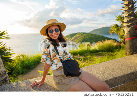 Travelers at Phromthep cape viewpoint at the south of Phuket Island, Thailand. Tropical paradise in Thailand. Phuket is a popular destination famous for tourists 76120251