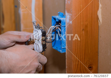 Replacing old broken an electrical outlet into the wall box 76120837