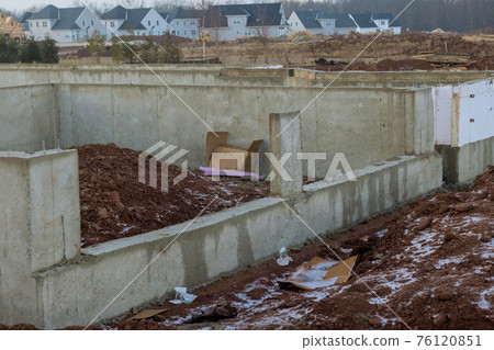 A newly completed cement foundation of a new housing development A newly completed cement foundation of a new housing development 76120851
