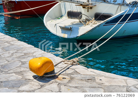 White shiny motorboat of modern design moored to pier on sea 76122069