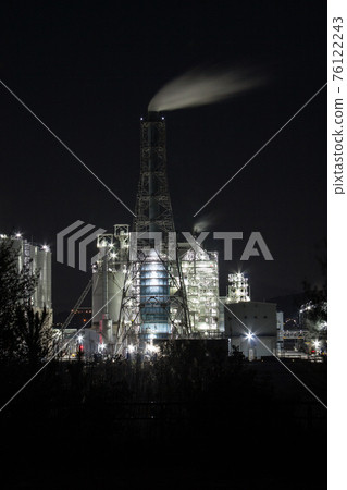 Thermal power plant at night illuminated by glittering lights 76122243