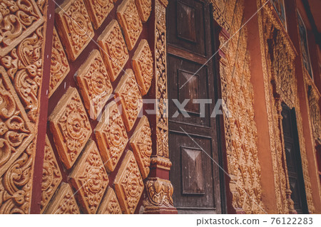 Elaborate bas-relief design in the walls of Munireangsey Pagoda, a Khmer Buddhist Temple in Can tho Mekong delta in Vietnam Elaborate bas-relief design in the walls of Munireangsey Pagoda, a Khmer Buddhist Temple in Can tho Mekong delta in Vietnam 76122283
