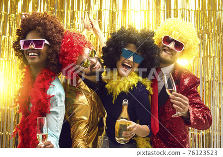 Happy millennials friends celebrating drinking champagne and making party Happy millennials friends celebrating drinking champagne and making party 76123523