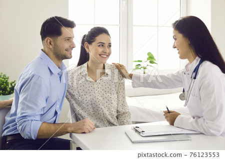 Female doctor consulting young couple patients in fertility clinic about IVF or IUI. Female doctor consulting young couple patients in fertility clinic about IVF or IUI. 76123553